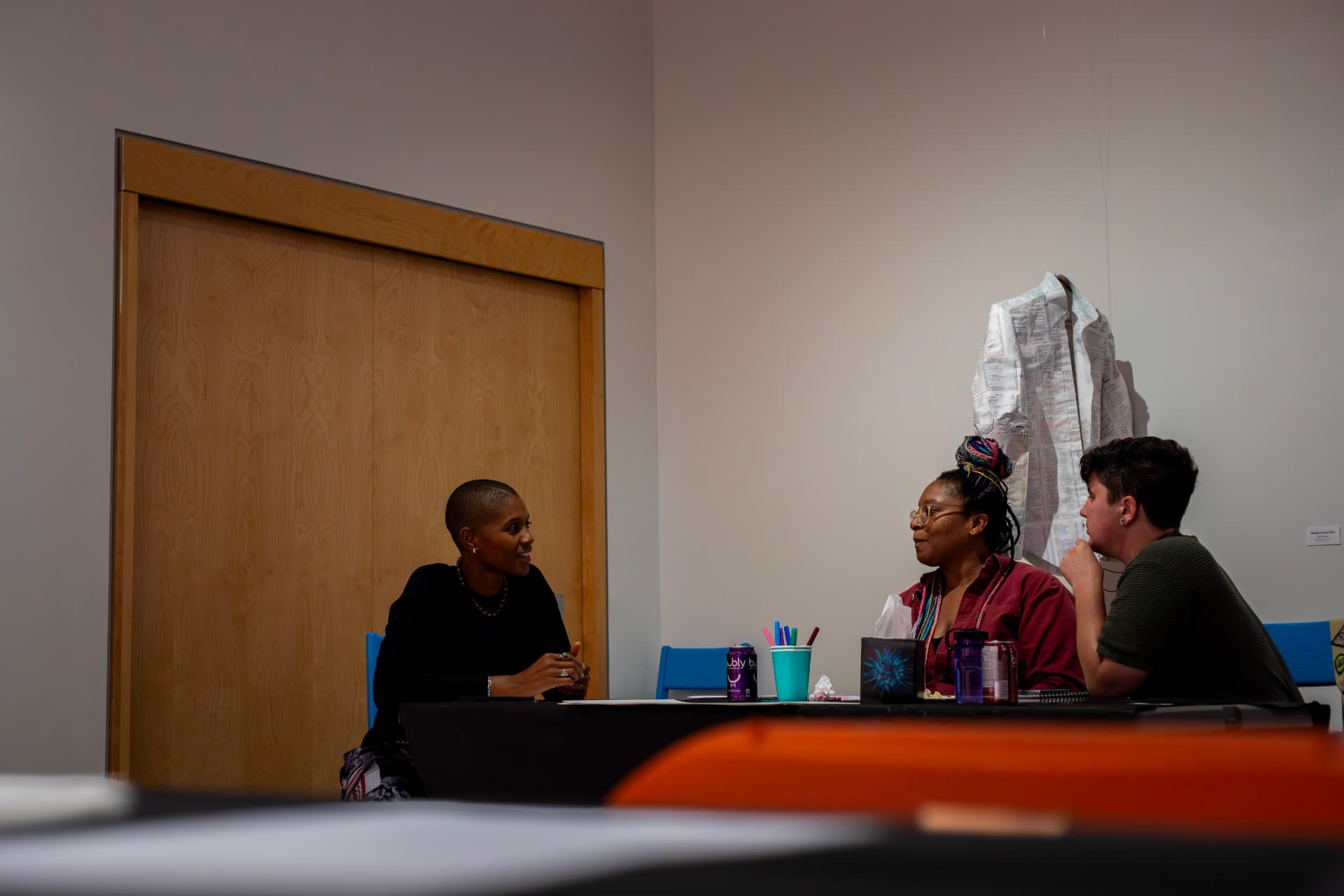 Guests in conversation around a shared table during a Second Wind & Co. session